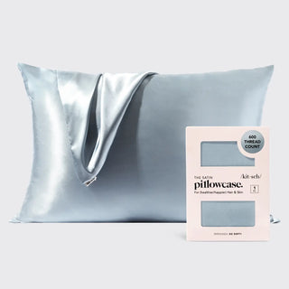 a silver pillow with a white box