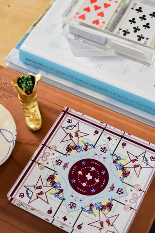 a box with a design on it next to a gold ashtray