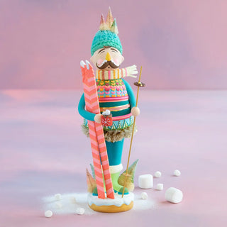 a figurine of a man holding skis and snow