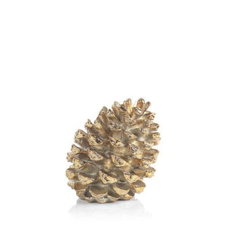a gold pine cone on a white background