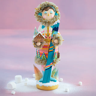 a statue of a woman holding skis
