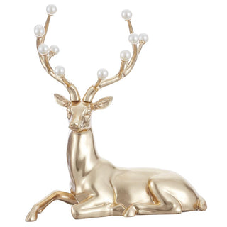 a gold reindeer with pearls on it