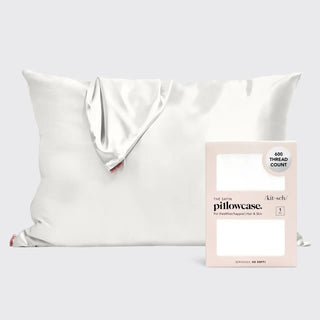 a white pillow with a white pillow and a white box