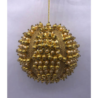 a gold and white beaded ball
