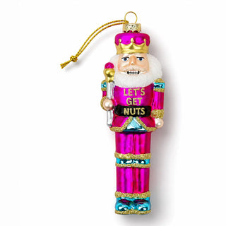 a nutcracker ornament on a white background