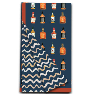a blue and white folded towel with bottles of alcohol