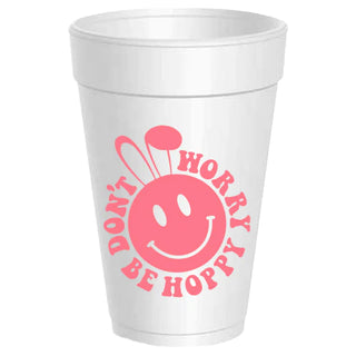 a white cup with a pink face and text