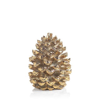 a gold pinecone on a white background