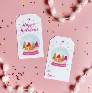 a pair of tags on a pink surface