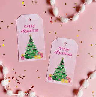 a pink gift tags with a tree and presents on it
