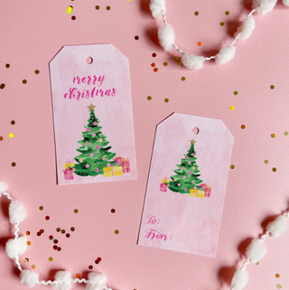 a pink gift tags with a tree and presents on it