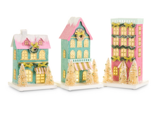 a group of houses with trees and lights