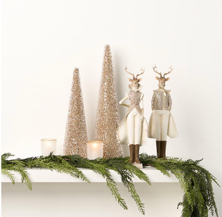 a shelf with a couple of statues and trees