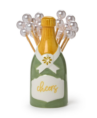 a bottle of champagne with pearls on sticks