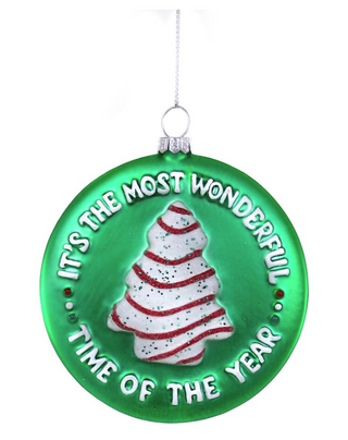a green christmas ornament with a white and red tree