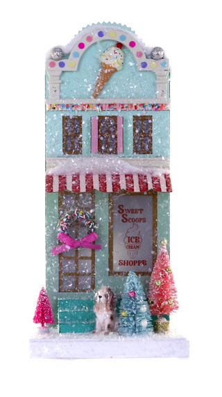 a small house with trees and snow
