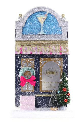 a small decorated building with a small tree