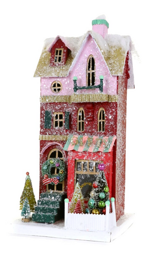 a toy house with trees and snow