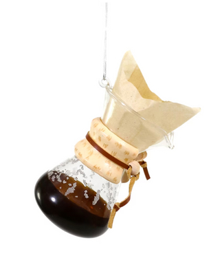 a glass flask with brown liquid inside