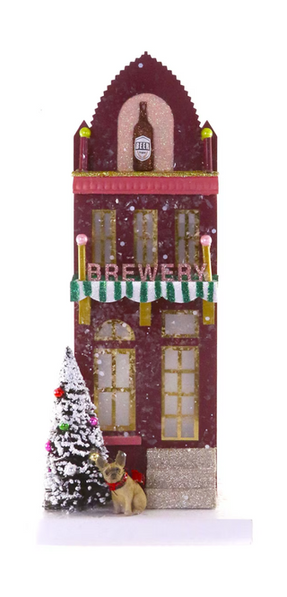 a small christmas tree and a building