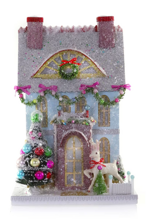 a christmas house with a deer and a tree
