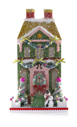 a house with snowman and trees