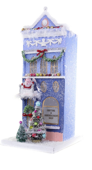 a blue house with a christmas tree and decorations
