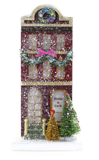 a house with a christmas tree and snow
