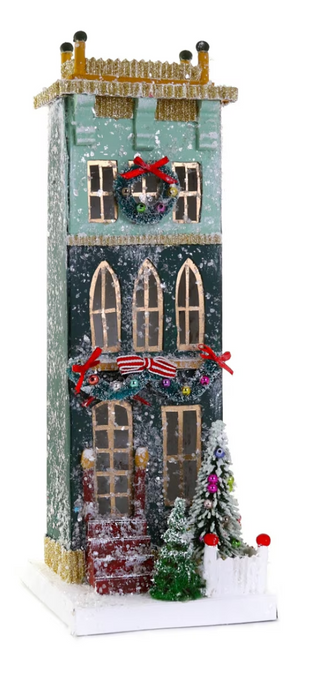 a miniature house with a wreath and a tree