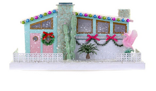 a house with a pink door and cactus