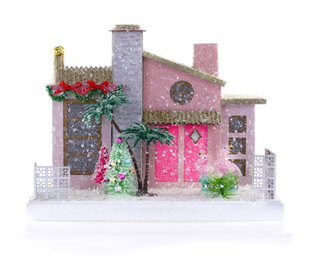 a pink and gold house with trees and a white fence